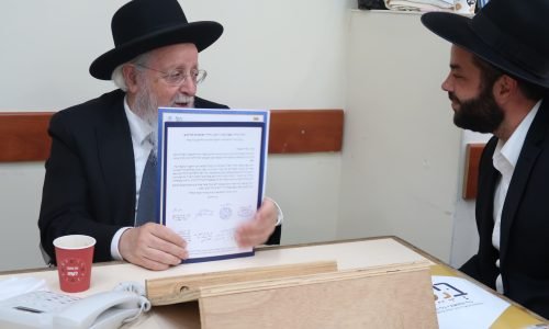 גאב"ד כתר תורה שליט"א מחזיק בידו את ה'קול קורא' עליו הוא חתום